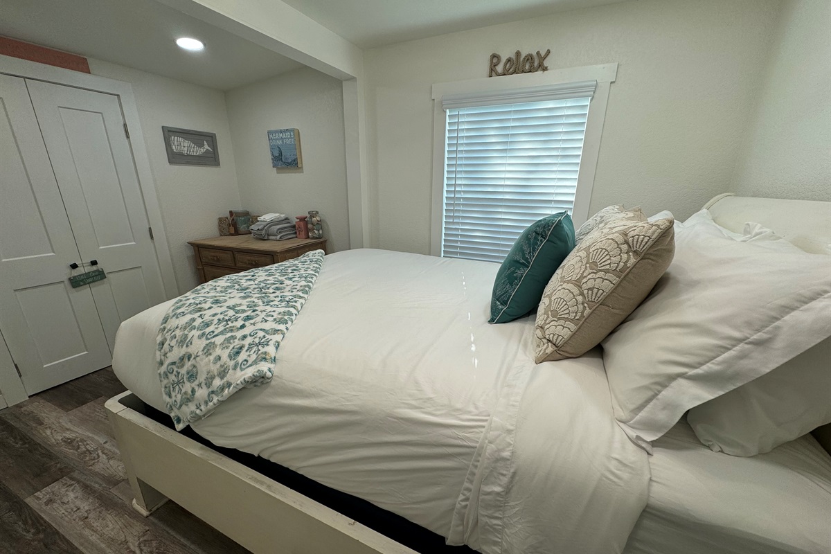 Bedroom with queen bed and smart tv