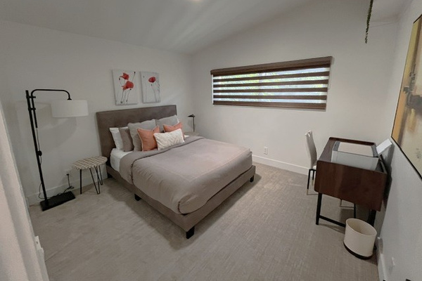 Guest Queen bedroom with large closet, desk with printer, and private courtyard view.