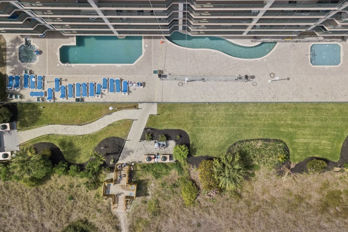 Looking down from the penthouse balcony, you can see the Windy Hill Dunes pool, lazy river, and hot tub.
