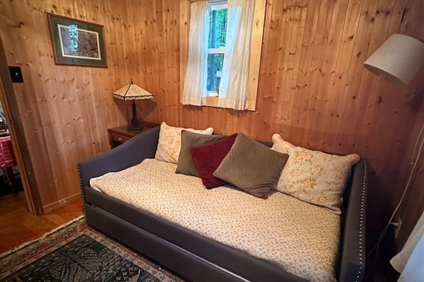 This twin bed with pull-out trundle is perfect for kids or extra guests. Bright and airy with dresser storage, it’s a cozy nook for rest or quiet time.