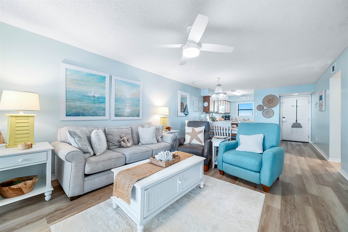 This well-appointed living space offers ample seating, coffee table, and a dining area with seating for six, creating a welcoming atmosphere.