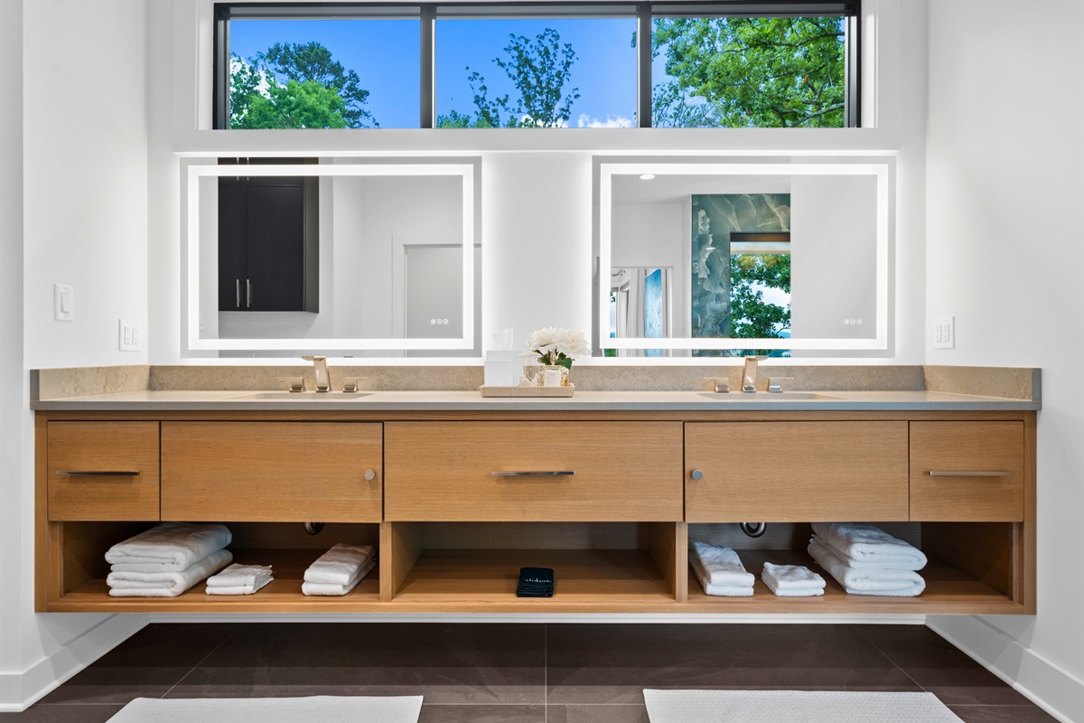 This elegant bathroom combines modern fixtures with beautiful natural light, creating a serene and luxurious space.