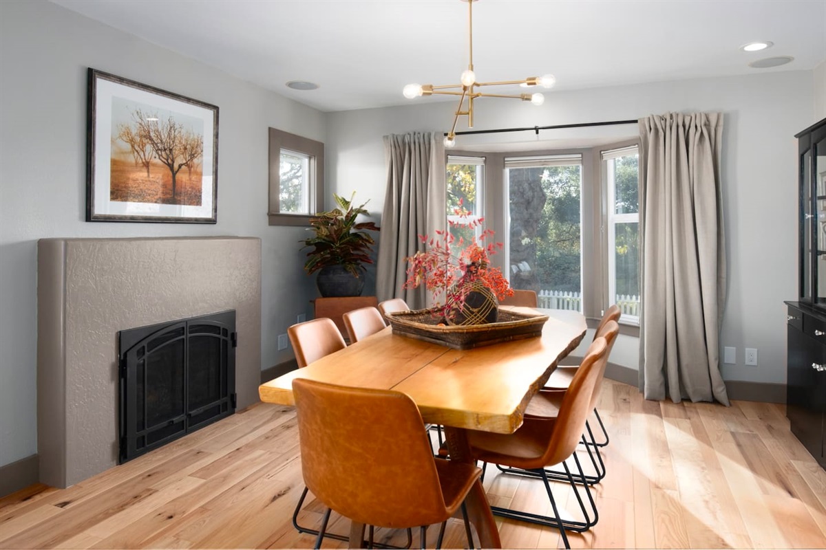The perfect setting for a dinner party with loved ones - dining table and fireplace.