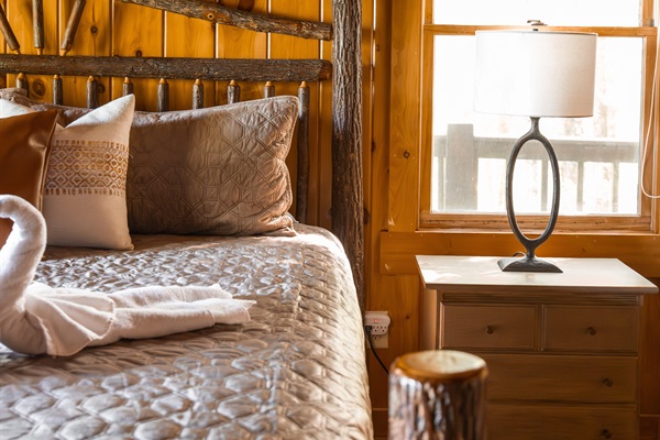 Thoughtful touches throughout the master bedroom from soft textures to warm wood accents, a plush king bed, and a sound machine designed for restful mountain nights.