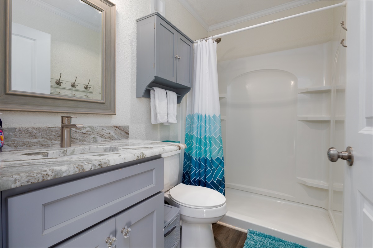 Spacious, spotless bathroom with tiled shower