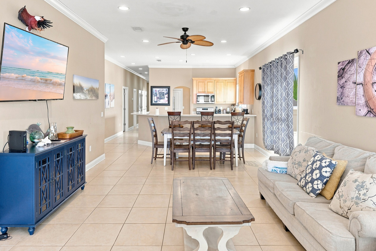 Open-concept great room with living, dining, and lagoon views
