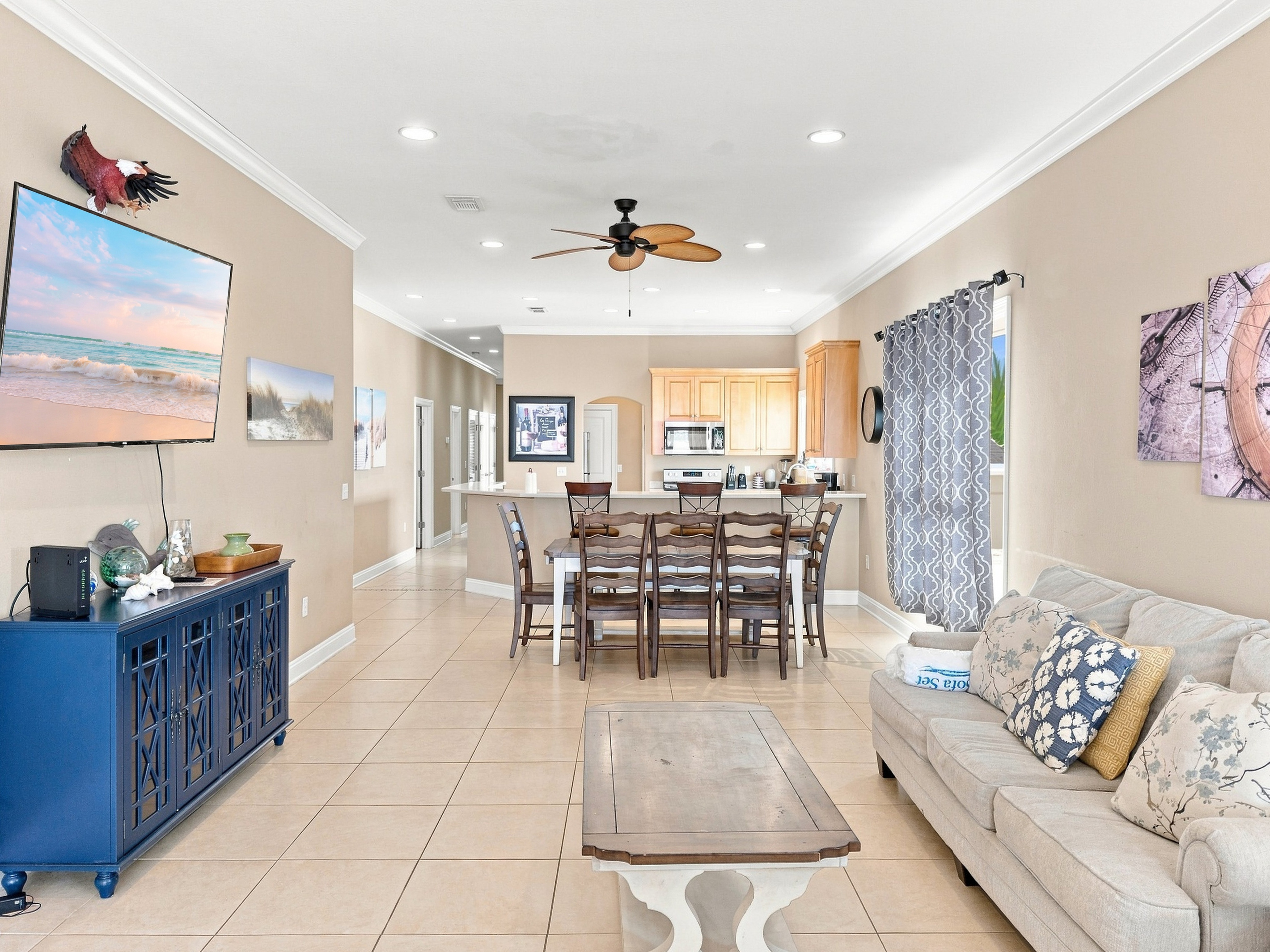 Open-concept great room with living, dining, and lagoon views