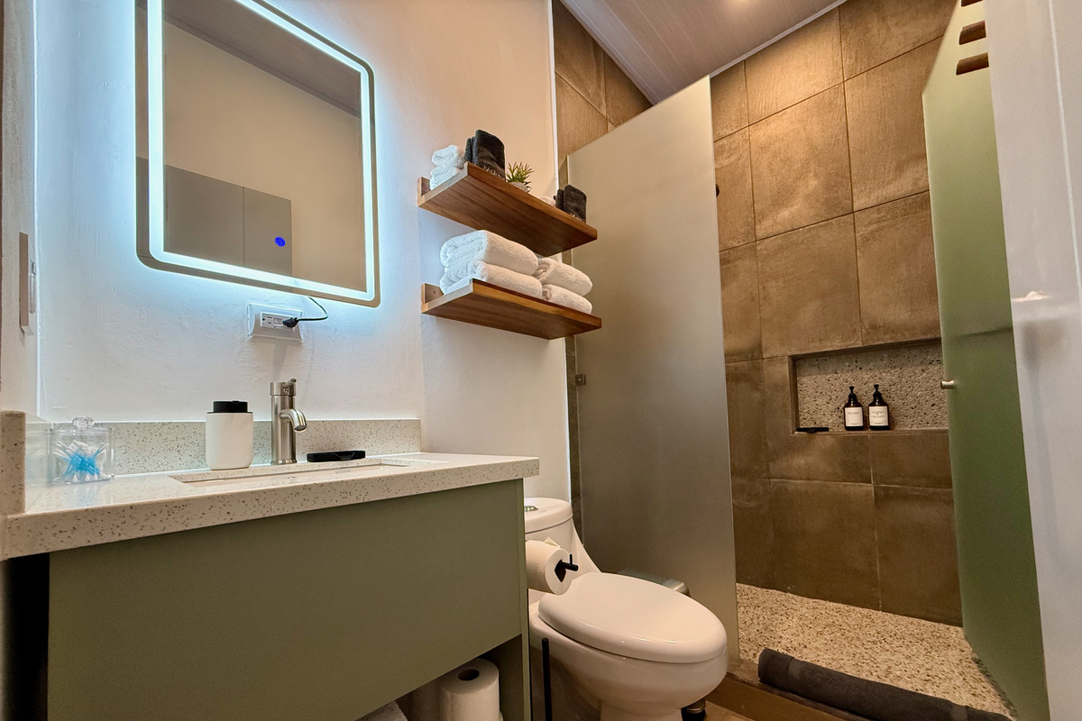 Second full bathroom — same rain shower, ceramic tile, LED vanity.
