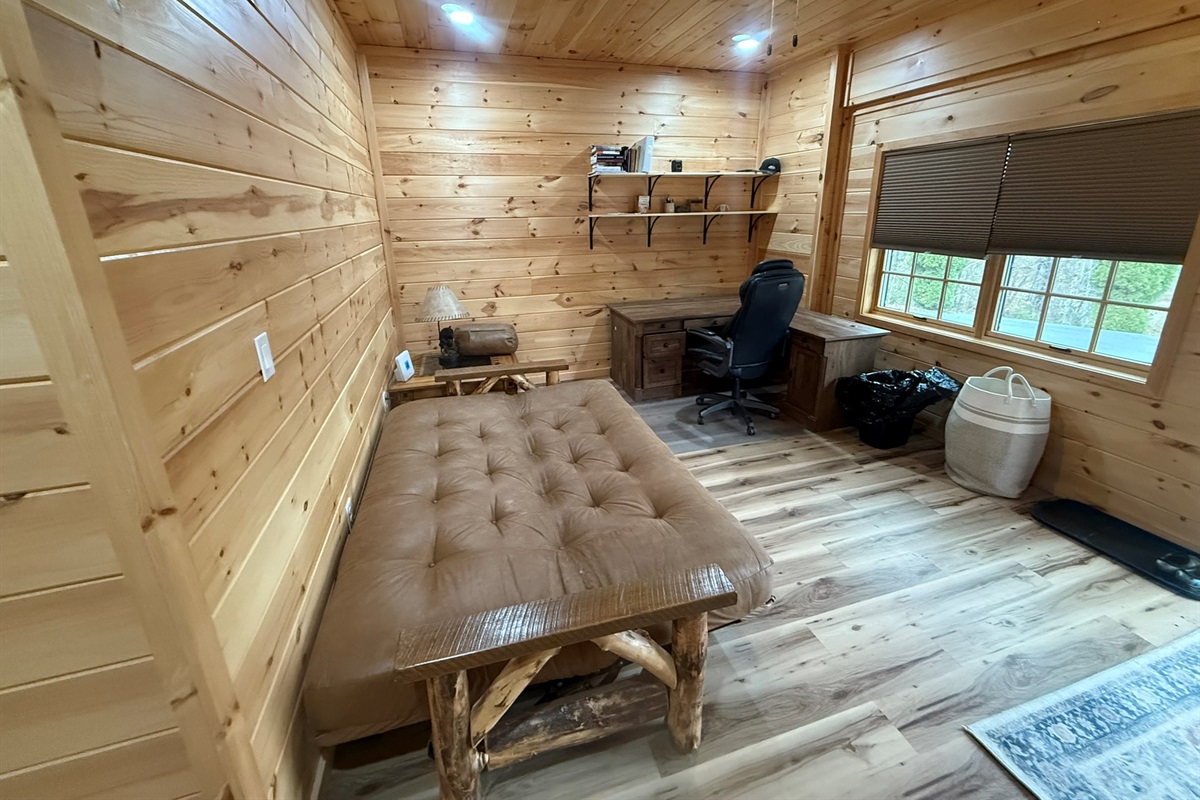 bedroom 2 in small cabin over garage. Linens, pillows, comforter are provided for sofa bed.