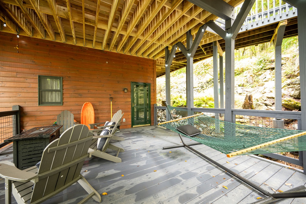 Under deck fun with a hammock, fire table and cozy chairs