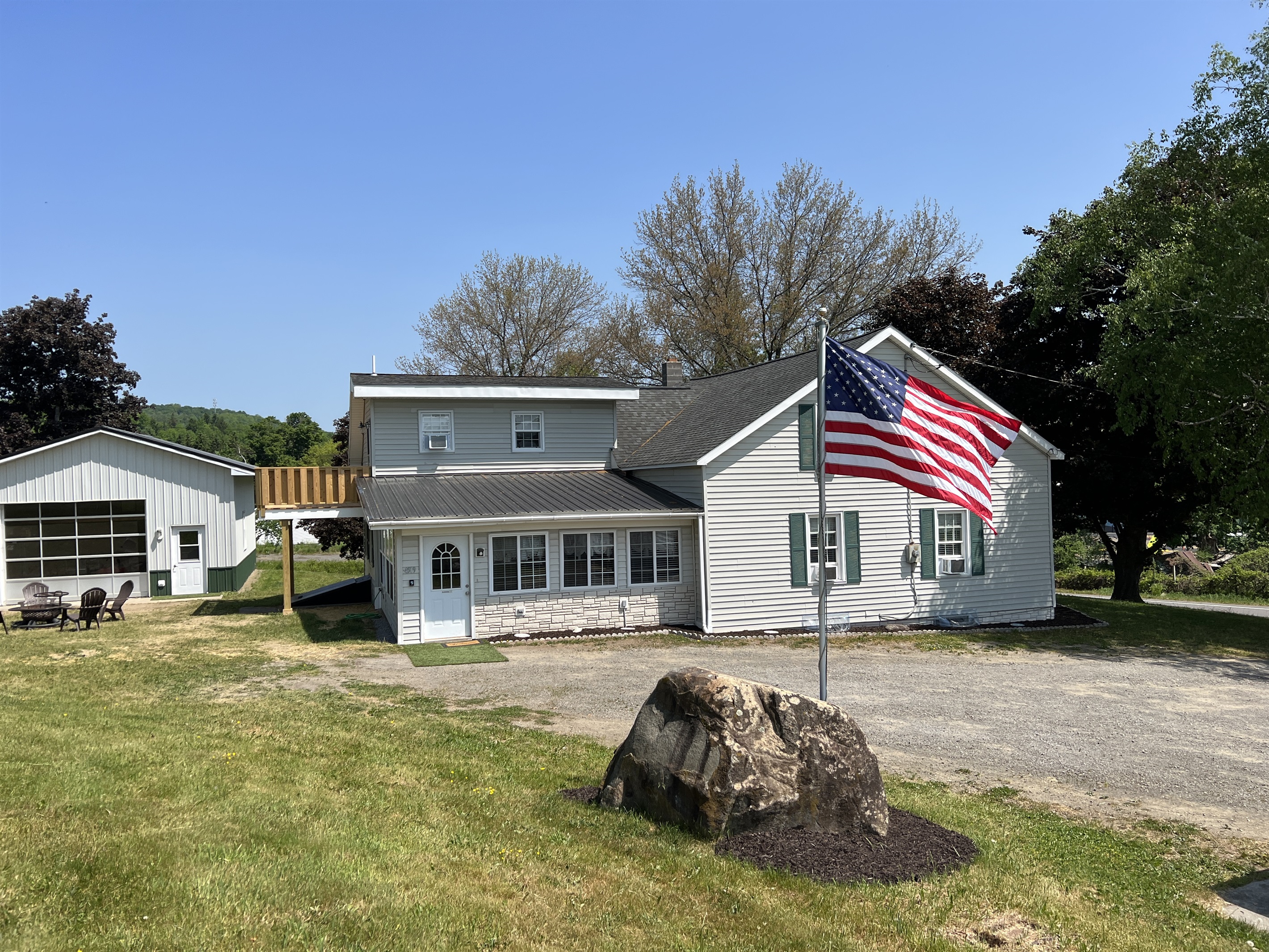 Roundtripper, side view of the house. The firepit and game room are to the left. The parking area is ample for your group!
