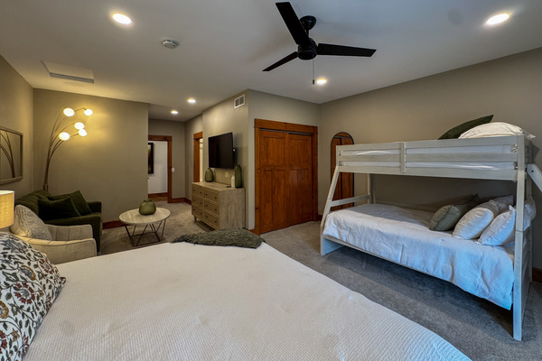 One of our two Jack and Jill bedrooms, each with a king bed and a queen-and-twin bunk bed. The two rooms have matching, mirrored layouts.