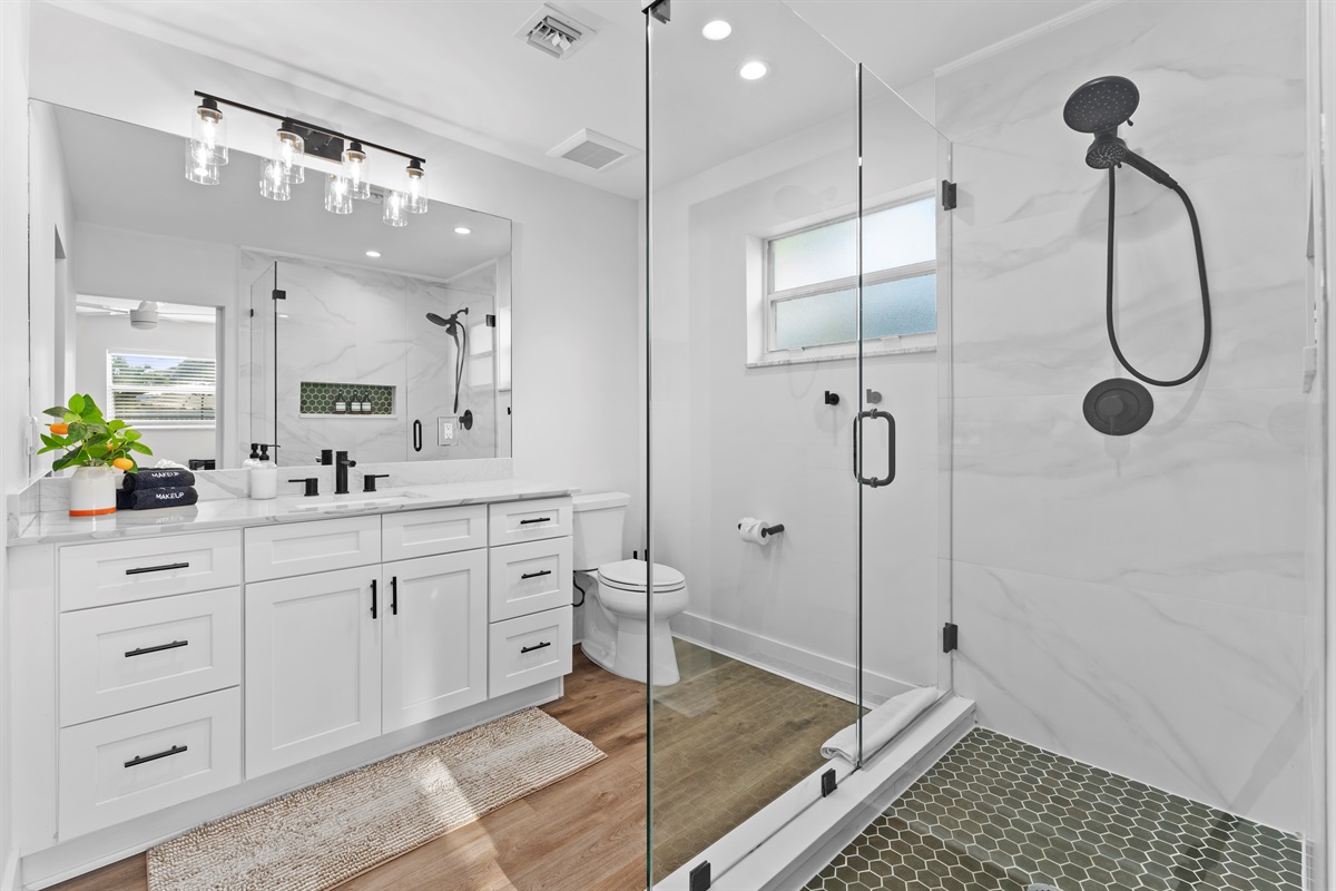 Spa-inspired primary bathroom with a sleek double vanity, frameless glass shower, and designer finishes for the ultimate refresh.