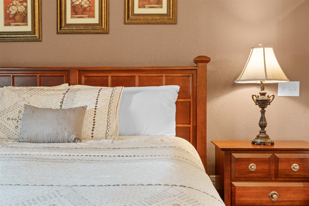 Soft bedding, warm lamps, and simple finishes keep the bedrooms inviting and restful.