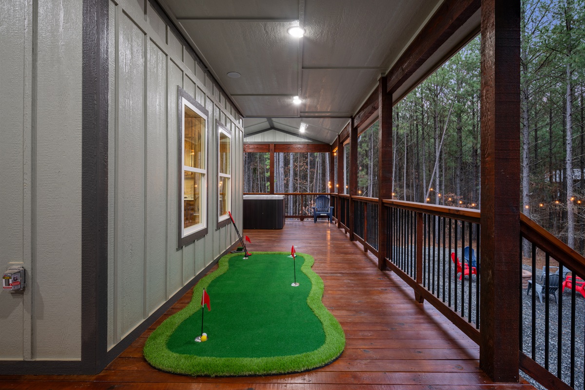 The long covered deck stretches along the back of the cabin, offering plenty of space to walk, relax, or simply take in the peaceful views of the surrounding trees.