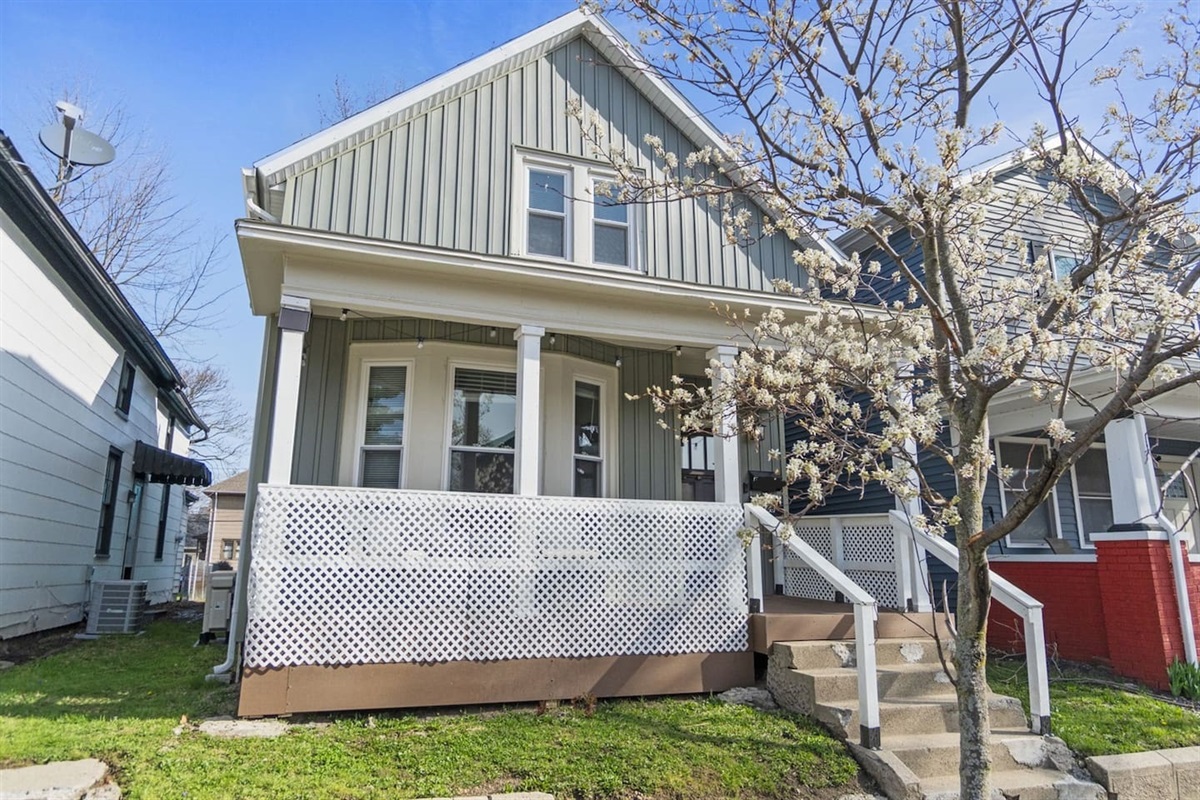 The front view of the property showcasing a charming porch, perfect for enjoying the outdoors.
