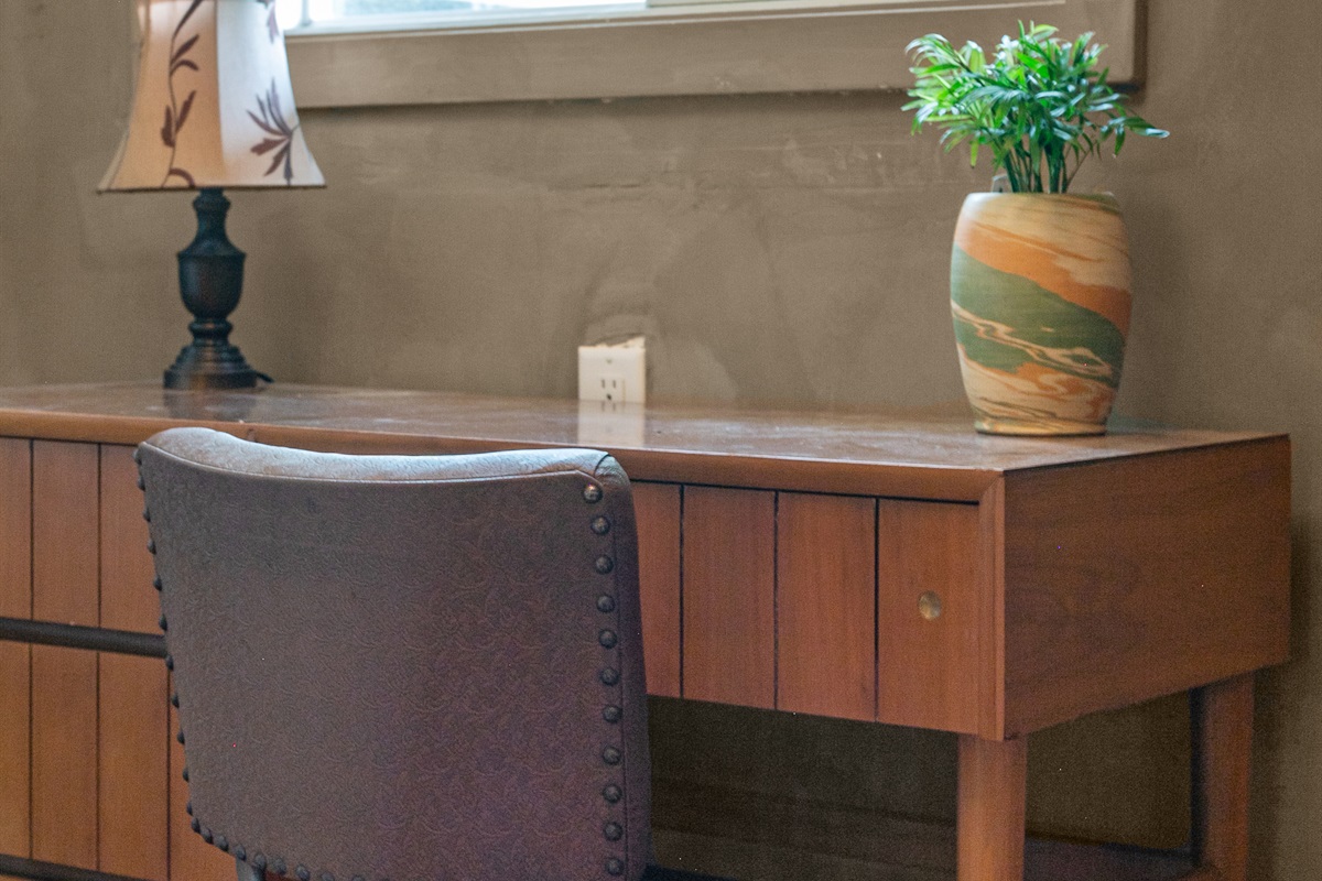 The den doubles as a quiet workspace, complete with a desk and chair. With Wi-Fi available throughout the home, it’s easy to stay connected while still enjoying the peace of your getaway.