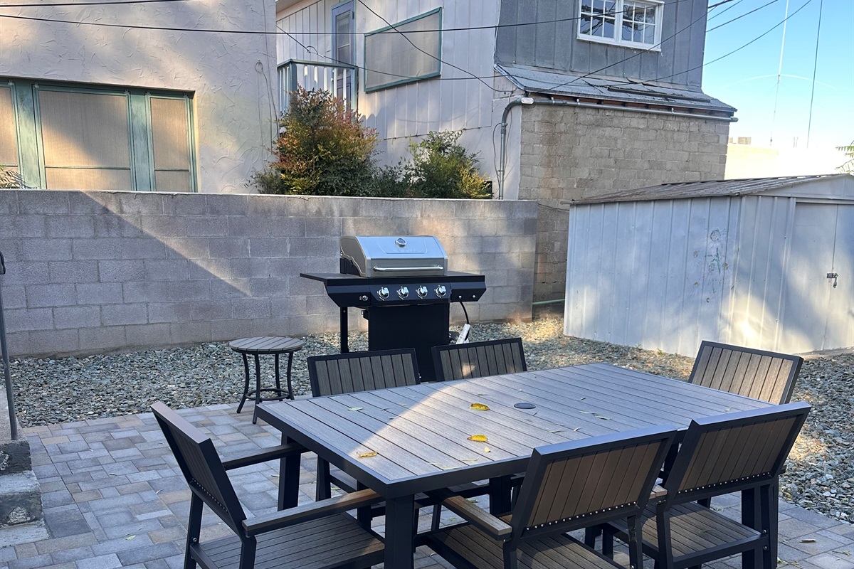 Fenced backyard with gate to access alley and shorter walk to Main Street.  Patio Table for 6 and Gas BBQ Grill.