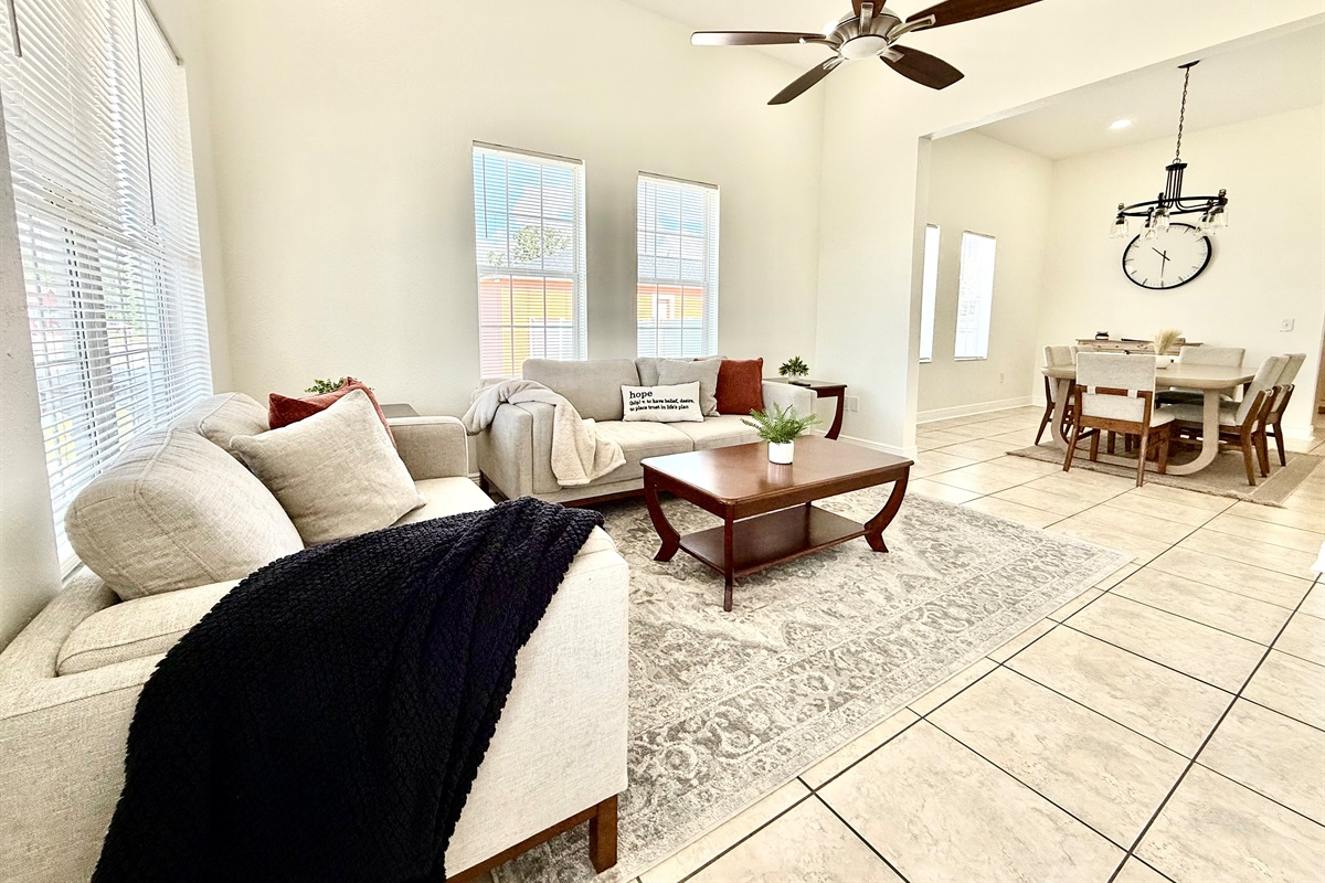 Soaked in natural sunlight, this welcoming living space features plush modern sofas and a smart TV for endless entertainment.