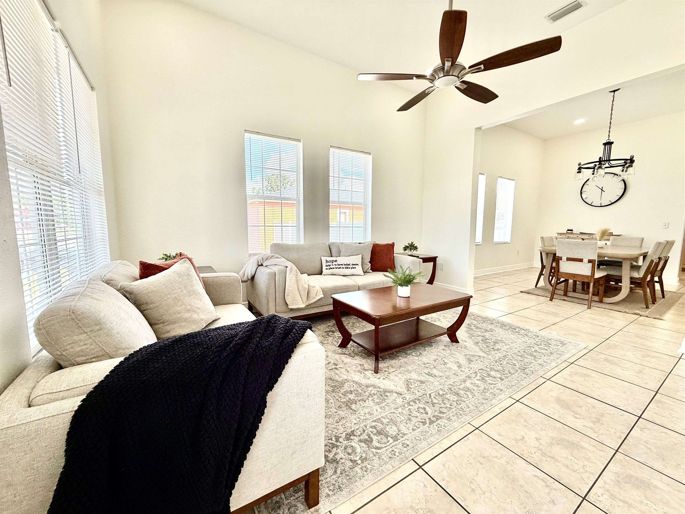 Soaked in natural sunlight, this welcoming living space features plush modern sofas and a smart TV for endless entertainment.