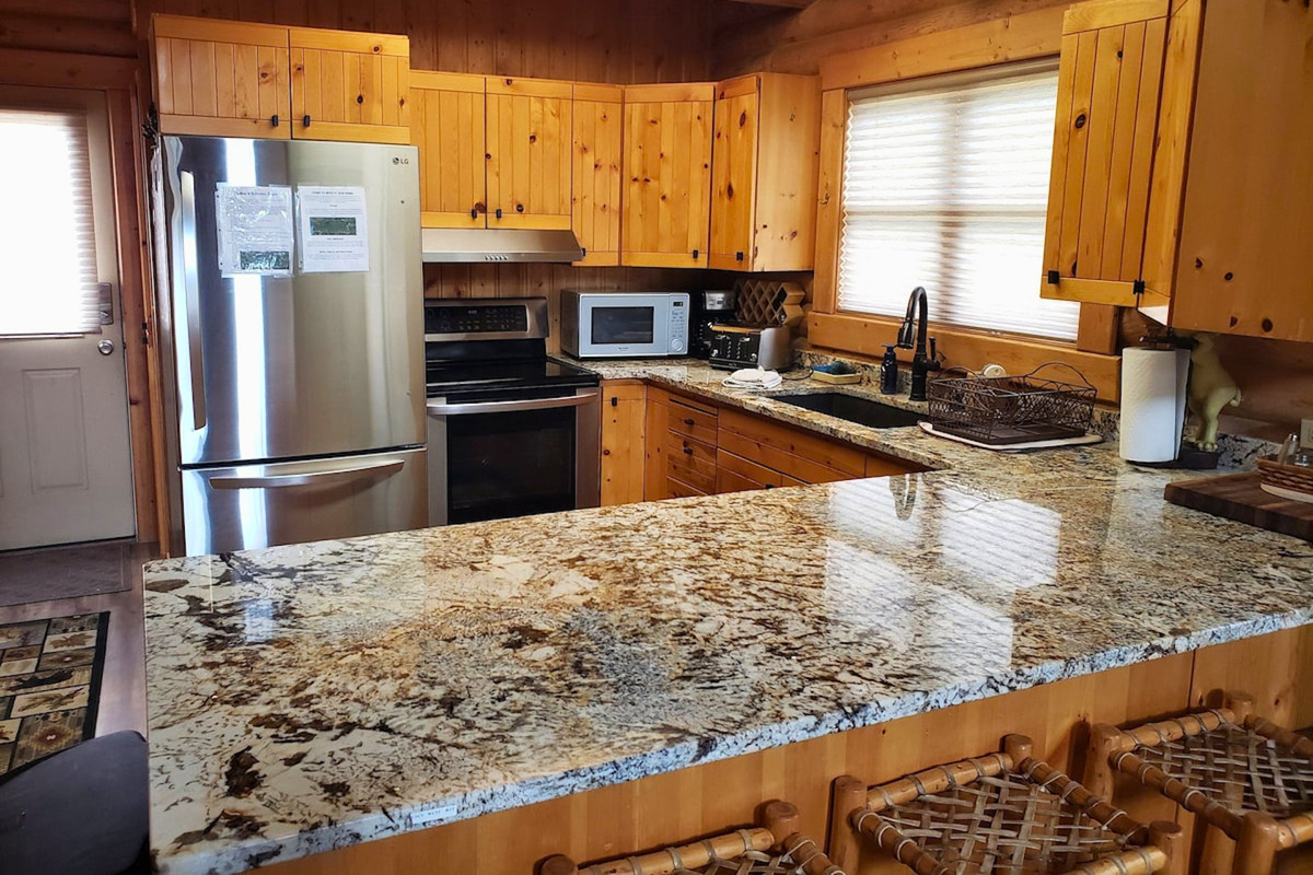 Large peninsula kitchen counter top for plenty of meal prep and serving space.