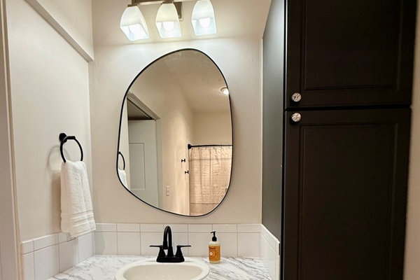 Large full ensuite bathroom attached to the second bedroom with updated fixtures, heat lamp, elongated oval toilet, high ceilings.