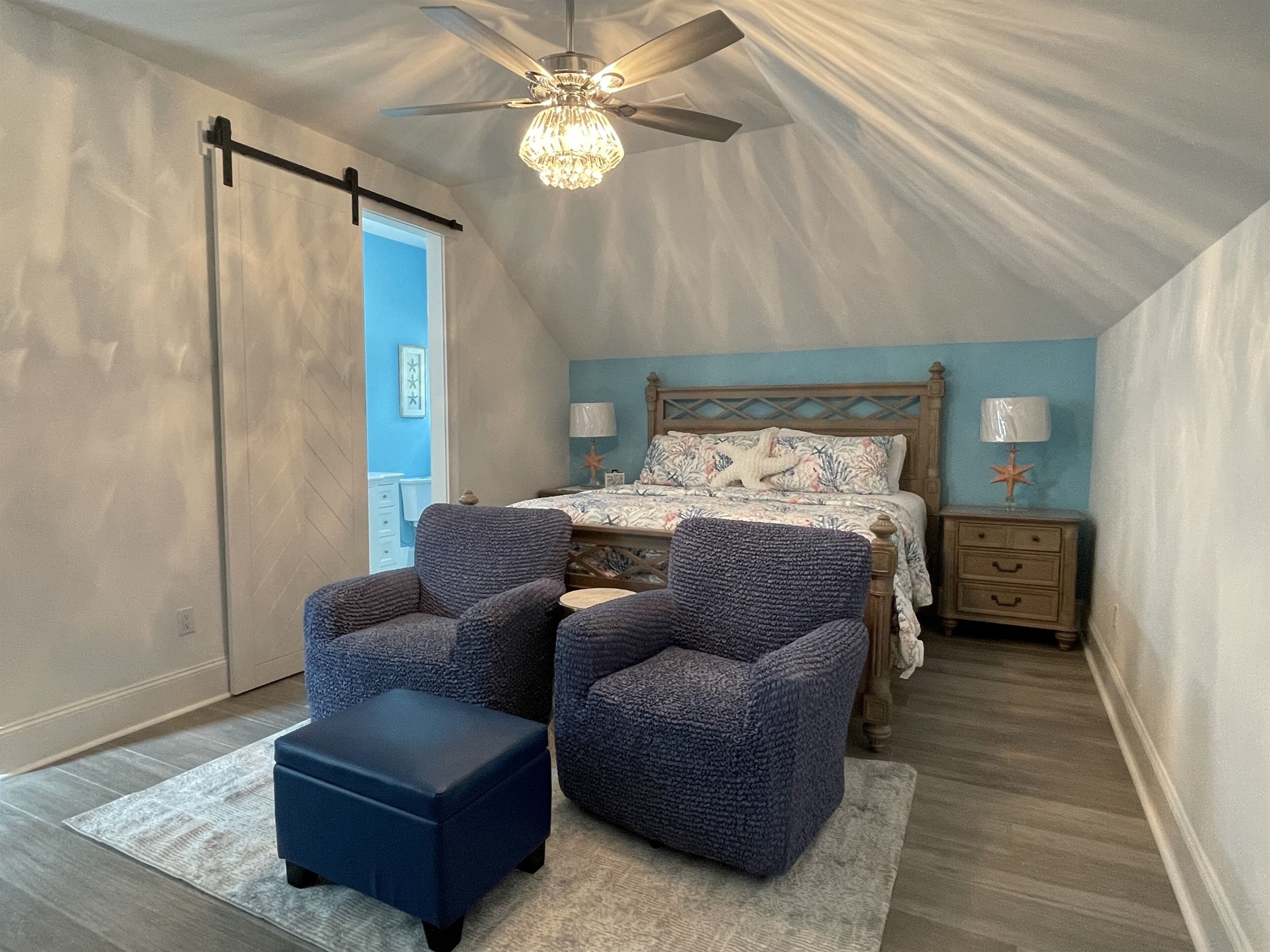 "Starfish Wishes" king bedroom w/sitting area. Barn door leads to ensuite bath