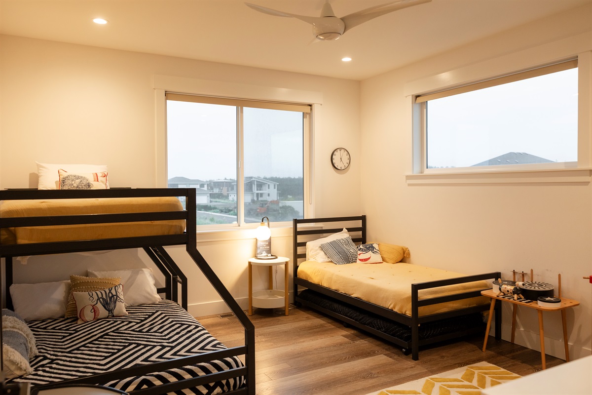 {Bunk Room} Upstairs kids’ room featuring a twin-over-full bunk, twin with trundle, TV, and plenty of toys — sleeps 4–5 kids comfortably.