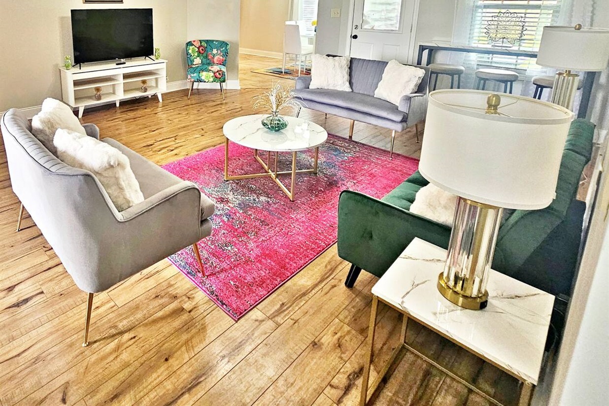 Kick back, relax in this comfy living room, and watch your favorite movie or show on the 55-inch flat-screen smart TV. The green sofa is the sleeper sofa!
Step out the door to the back patio & fenced-in backyard. 