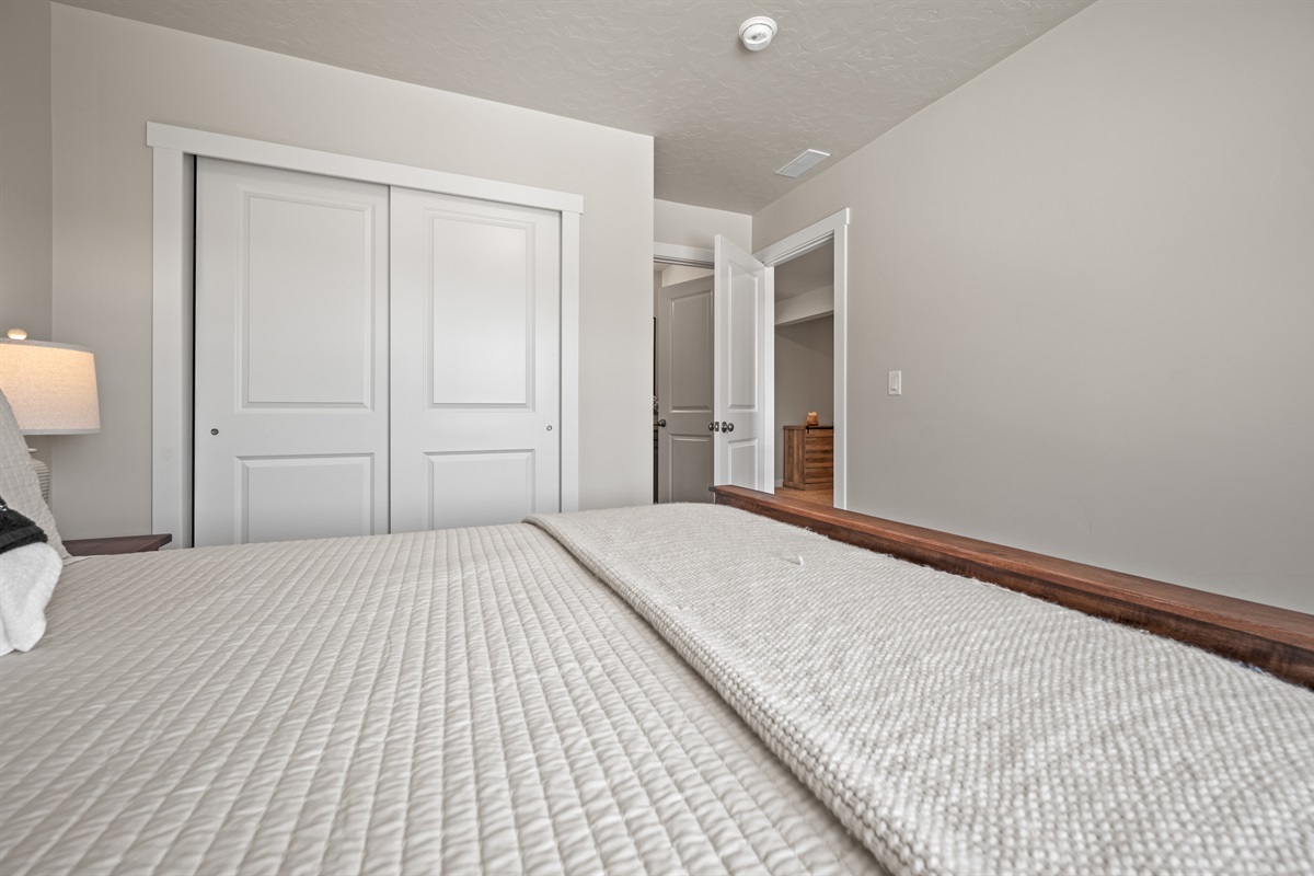 Relax in style with a plush queen bed, scenic views, soft lighting, and ample storage, including a double closet and coat rack.