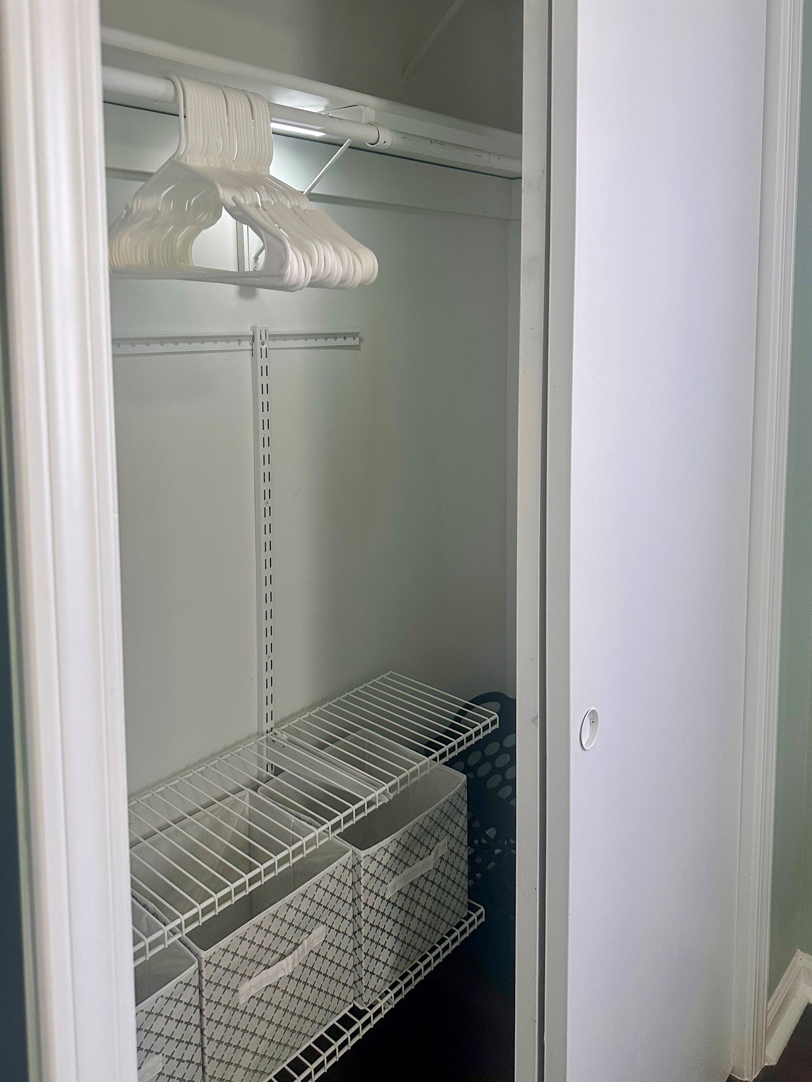 Primary bedroom closet with hanging space, shelving, and storage baskets. Designed to comfortably accommodate extended stays, allowing guests to fully unpack and settle in.