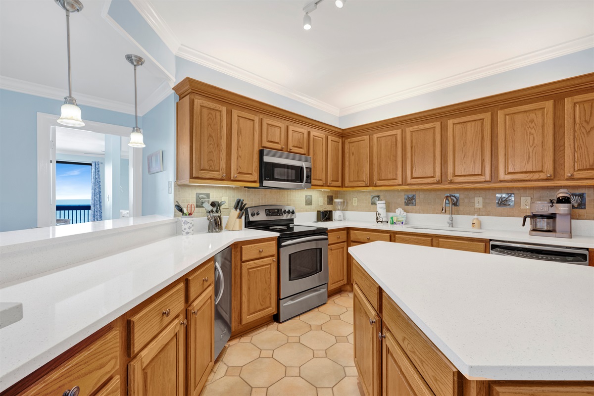 Kitchen with quartz cabinets, tiled backsplash and stainless steel appliances