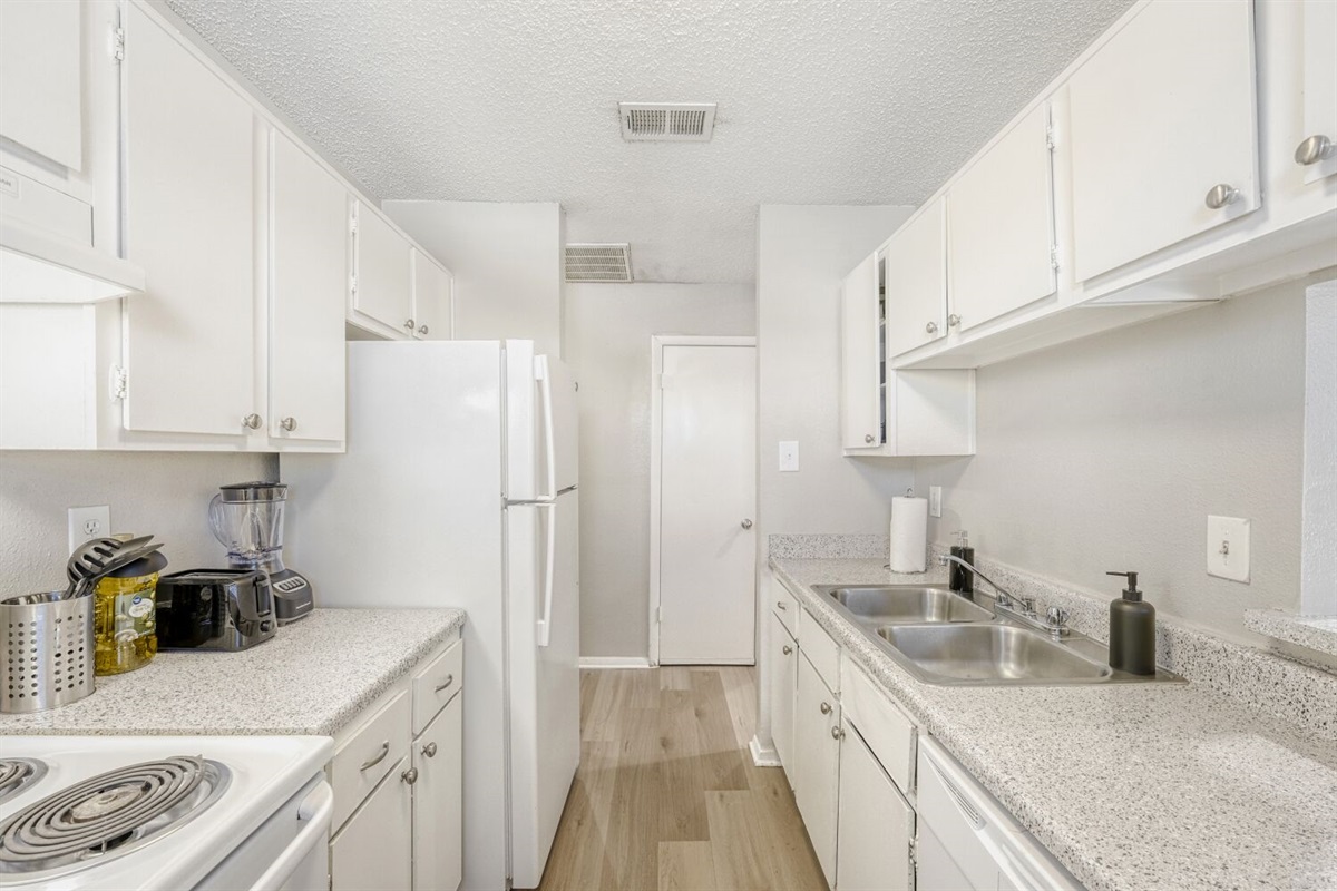 Bright galley kitchen with clean lines and modern simplicity.