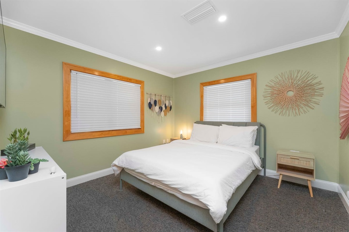 Guest bedroom with queen bed and smart tv