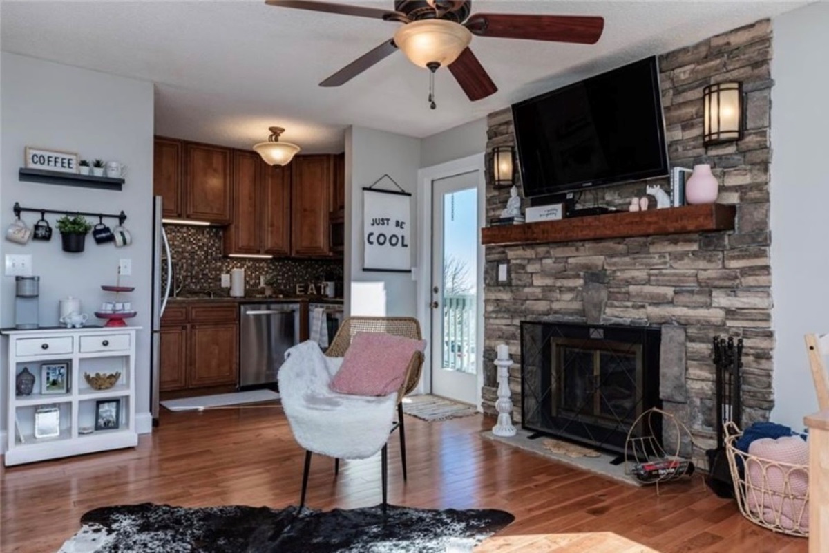 Kitchen with coffee station off the living room and door leading to the smaller balcony.