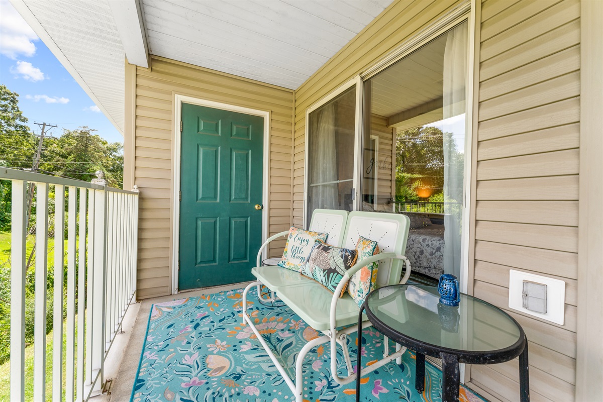A cozy seating nook on the deck gives you a peaceful spot to read, chat, or simply take in the greenery.