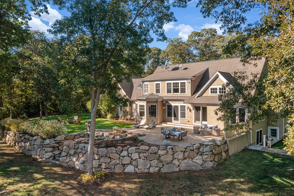 A full layout of lakeside living—grill, firepit, seating, and the water just steps away.