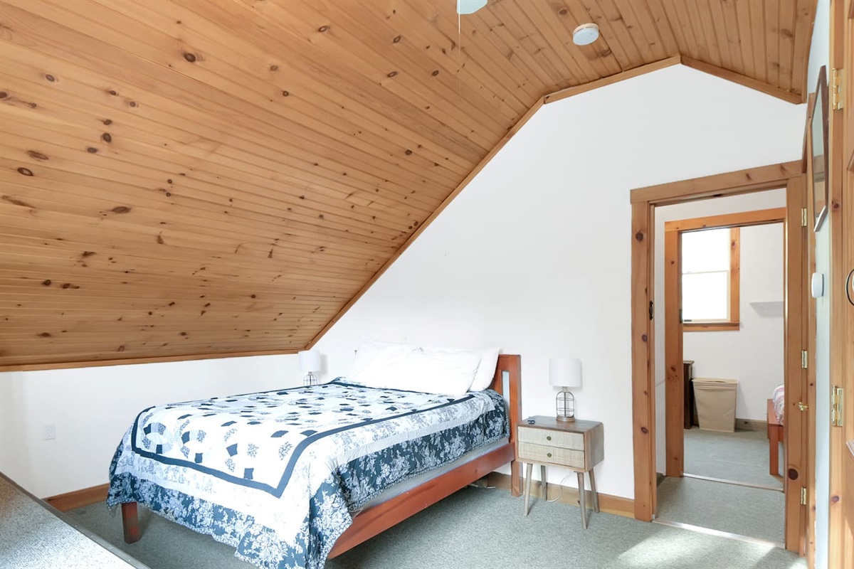 The main bedroom of the home has a cozy queen sized bed that and has it's own private deck!