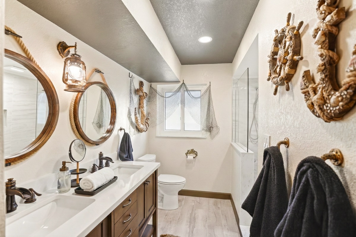 The Salty Shadow – A shared Jack‑and‑Jill bath with shower and twin vanity. Where mermaids and sea monsters cross paths, this hideaway keeps the crew fresh, polished, and ready for the next ad