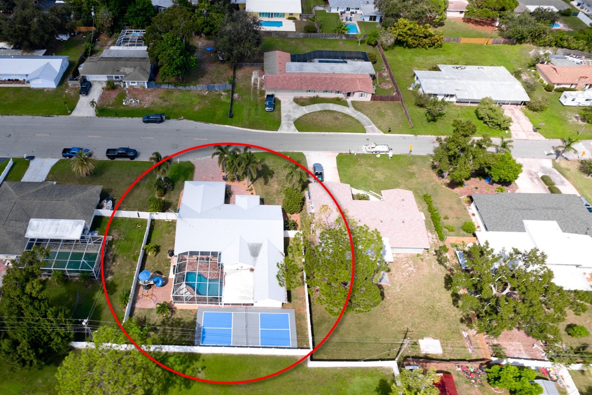 Your home away from home stands out from the sky — with a refreshing pool, private pickleball court, and inviting neighborhood surroundings that define Florida living at its best.