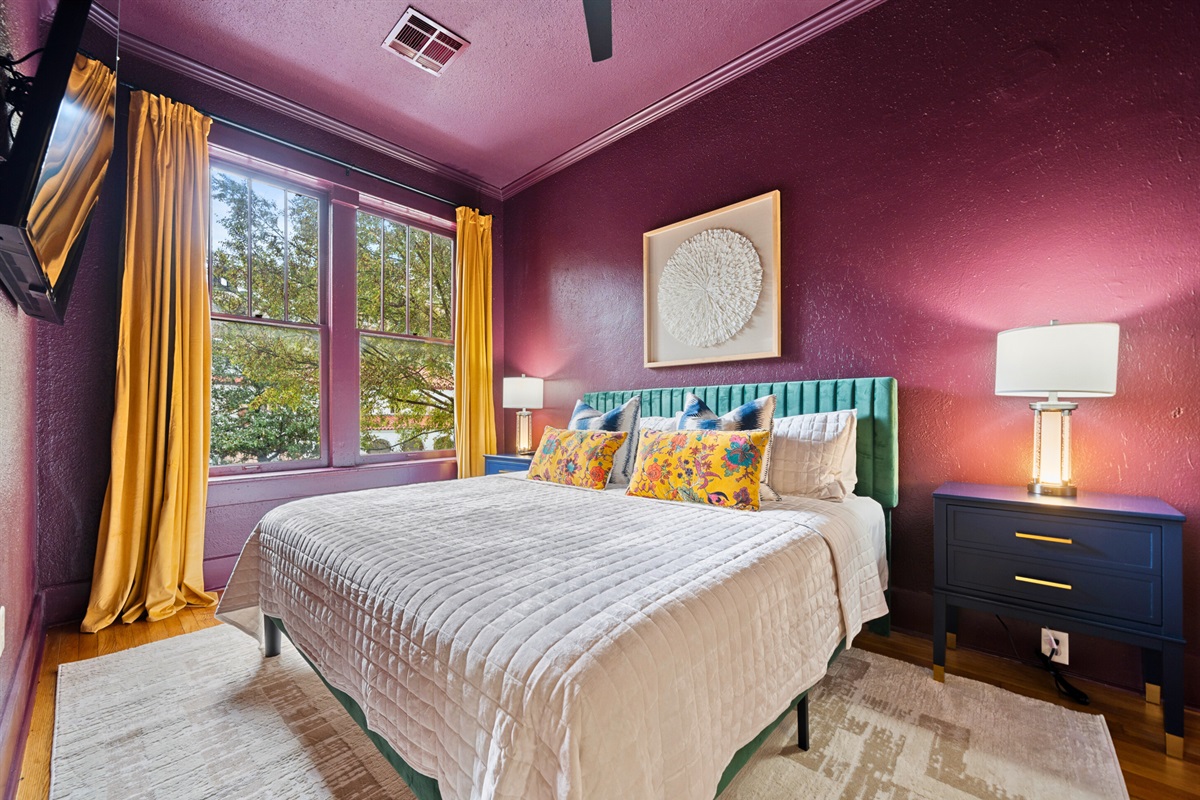 The bedroom’s rich tones, cozy bedding, and elegant details create a warm and inviting place to rest.