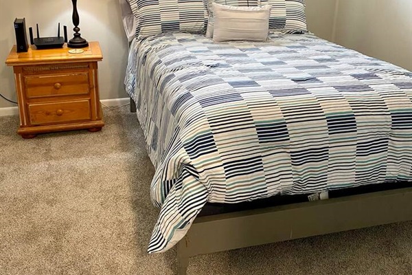 A secondary queen bedroom with a full closet