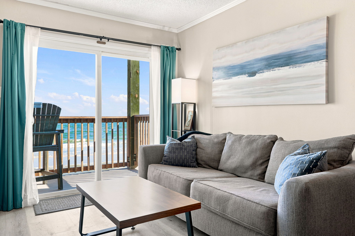 Relax and unwind in the inviting living space, where coastal comfort meets stunning ocean views just beyond the balcony