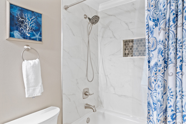 Updated master shower with quartz countertops and tile. Porcelain steel tub.