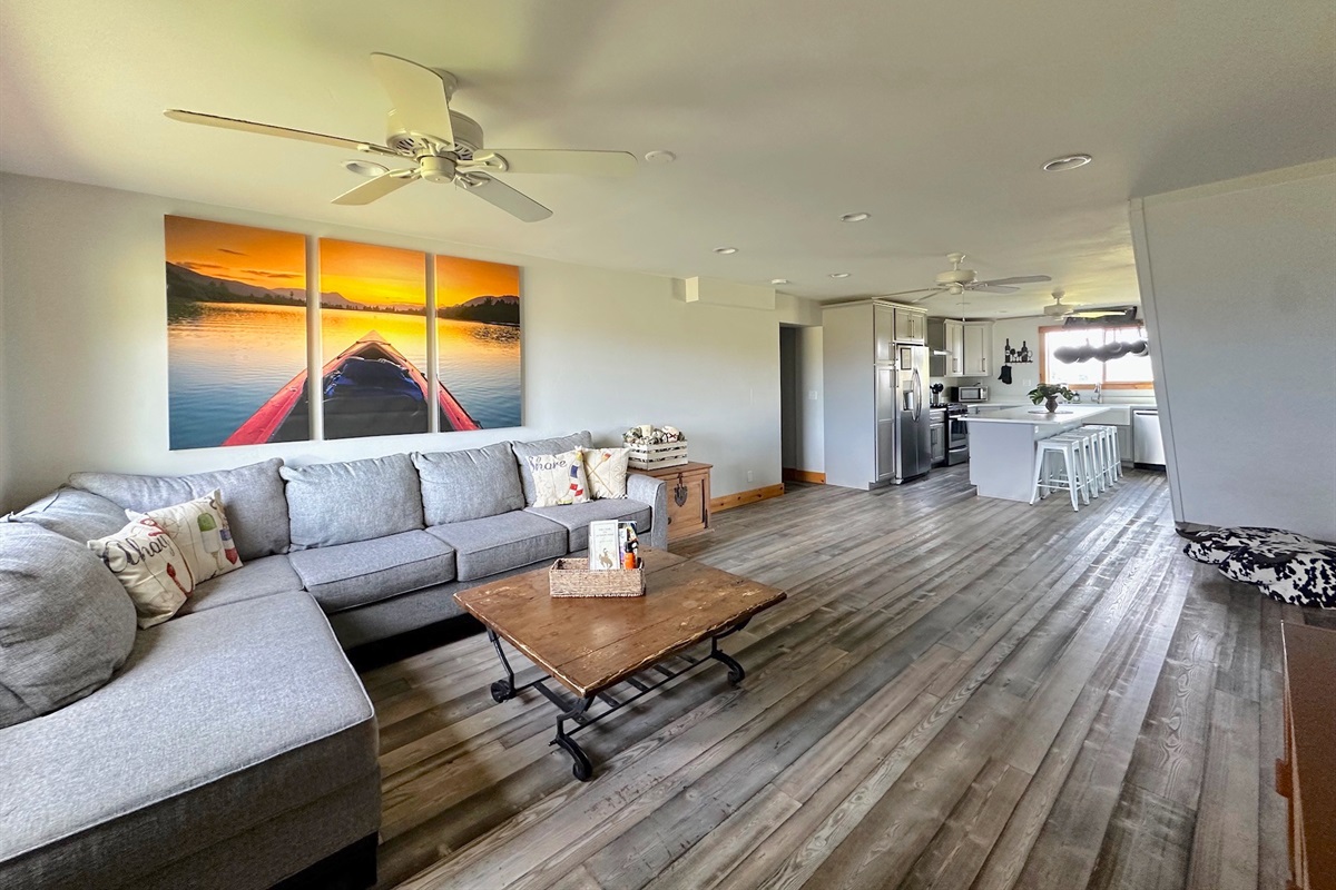 The living room provides a large, comfortable sofa for lounging.