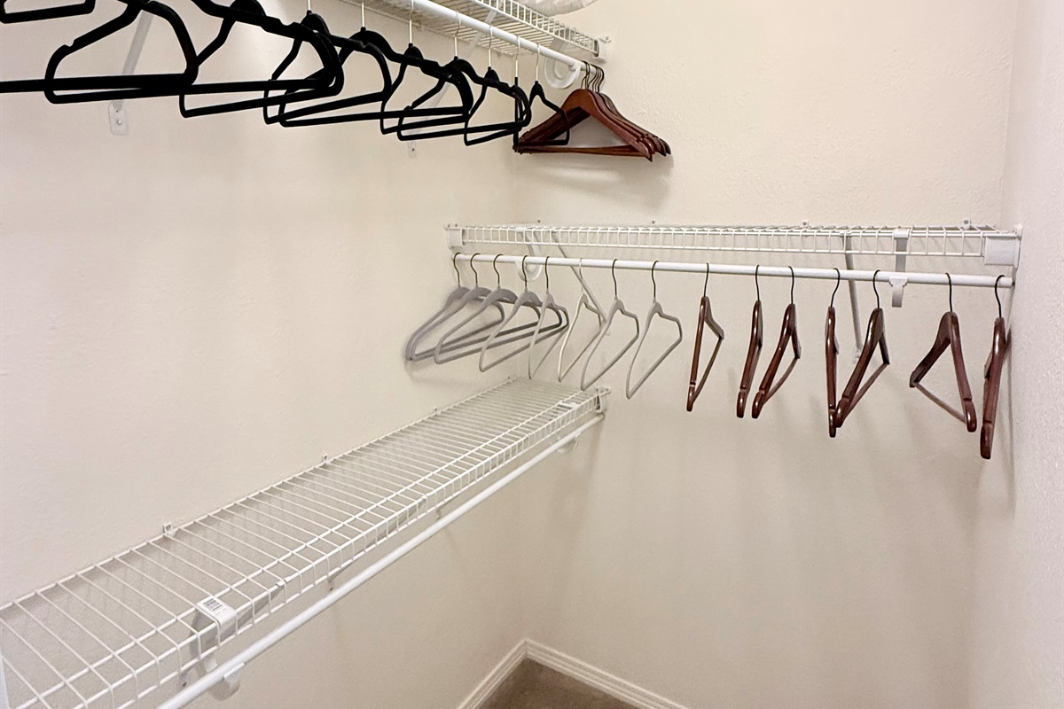 Walk in closet in primary bedroom.