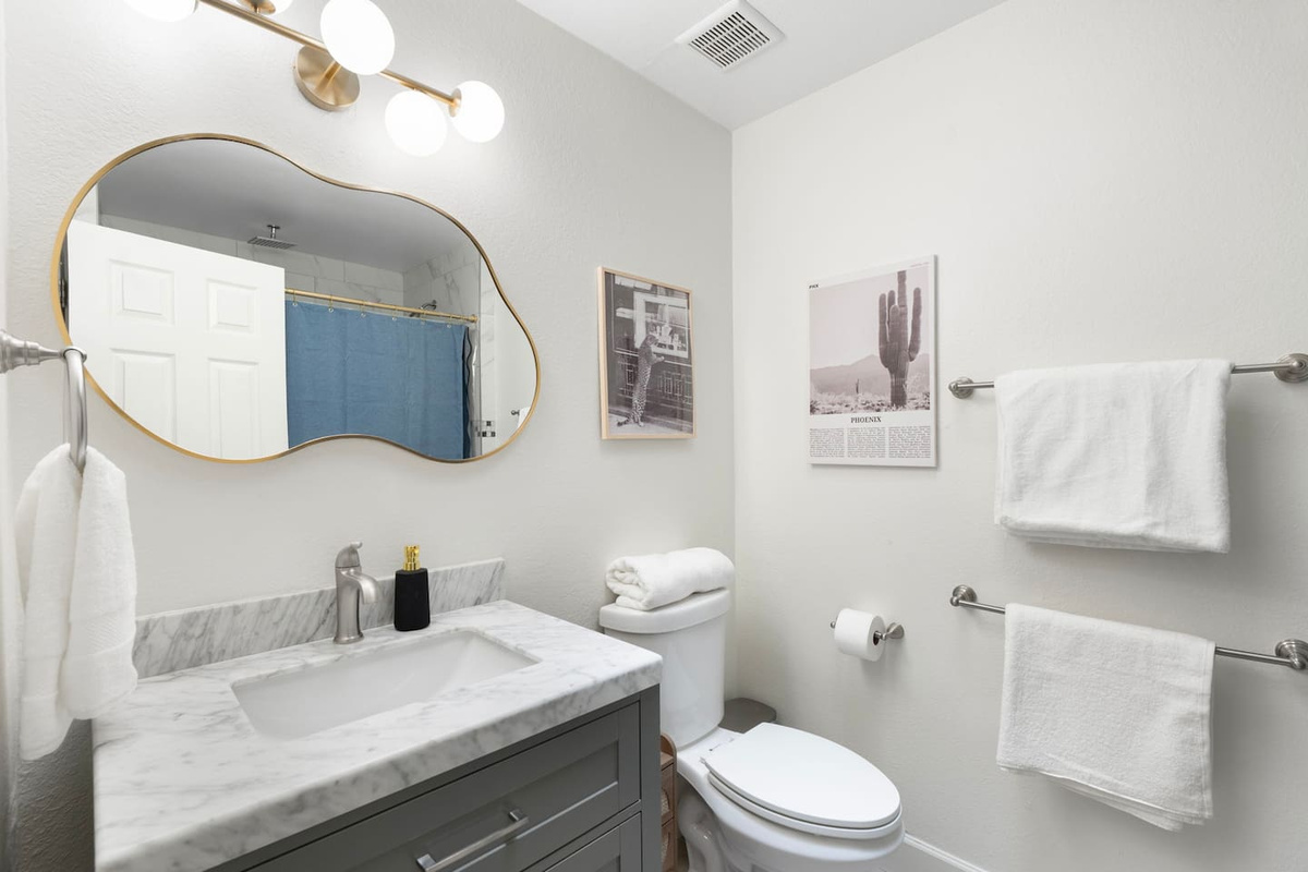 Modern guest bath with marble counters, contemporary fixtures, and designer touches—clean, spa-inspired, and thoughtfully appointed.