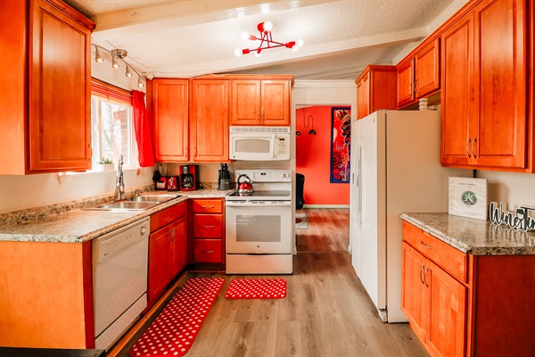 A sleek white stove and dishwasher set the tone for a kitchen that's both functional and stylish.