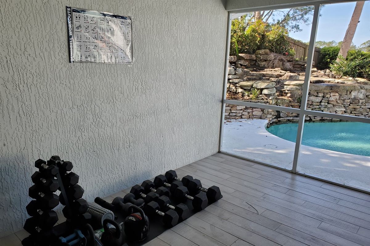 Fitness room free weights and ping pong table - screened in room.