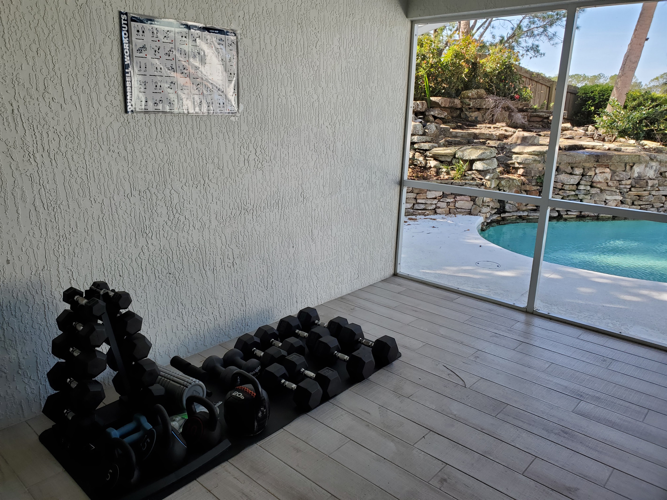 Fitness room free weights and ping pong table - screened in room.